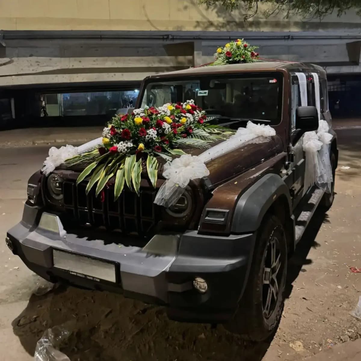 Wedding car decorated with white and red roses